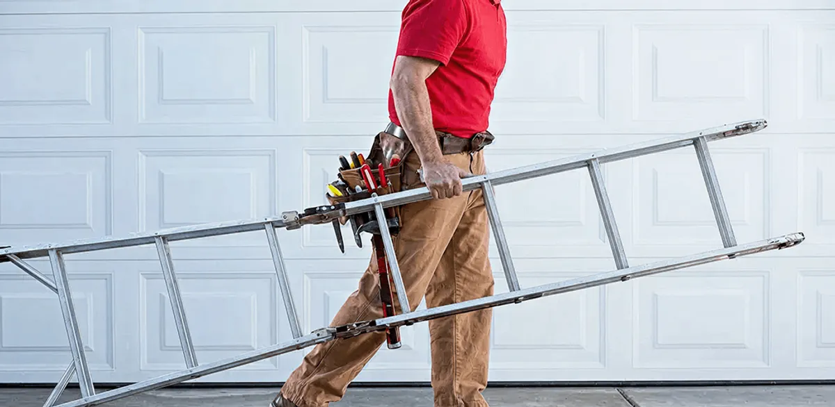 Garage door repair technician arriving with tools and ladder in Aurora, CO