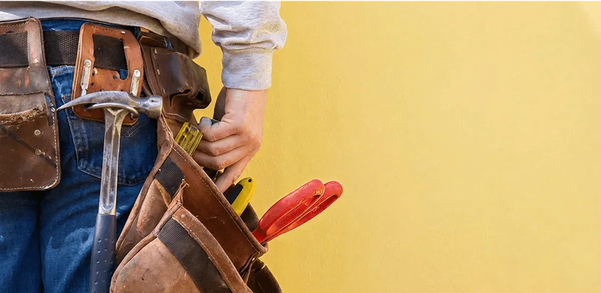 Handyman with tool belt ready for home repairs and maintenance in Aurora, CO